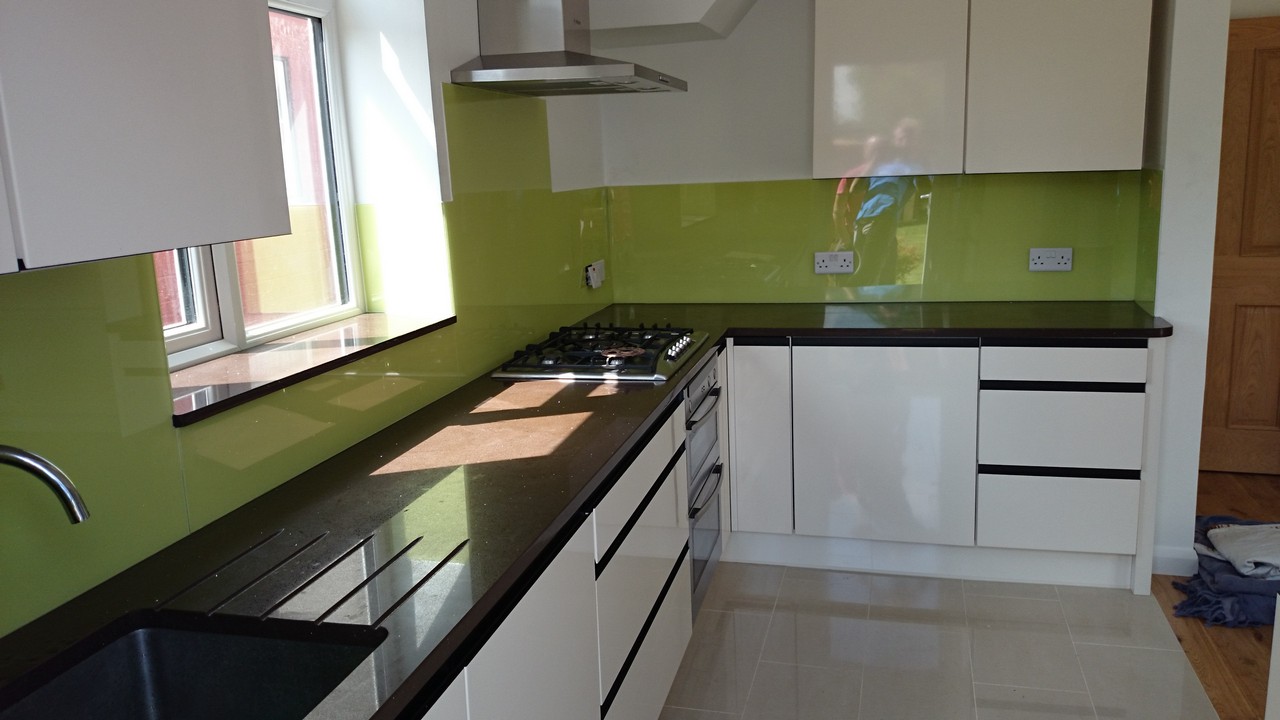 Lime green glass kitchen splashback installed by Buckingham glaziers
